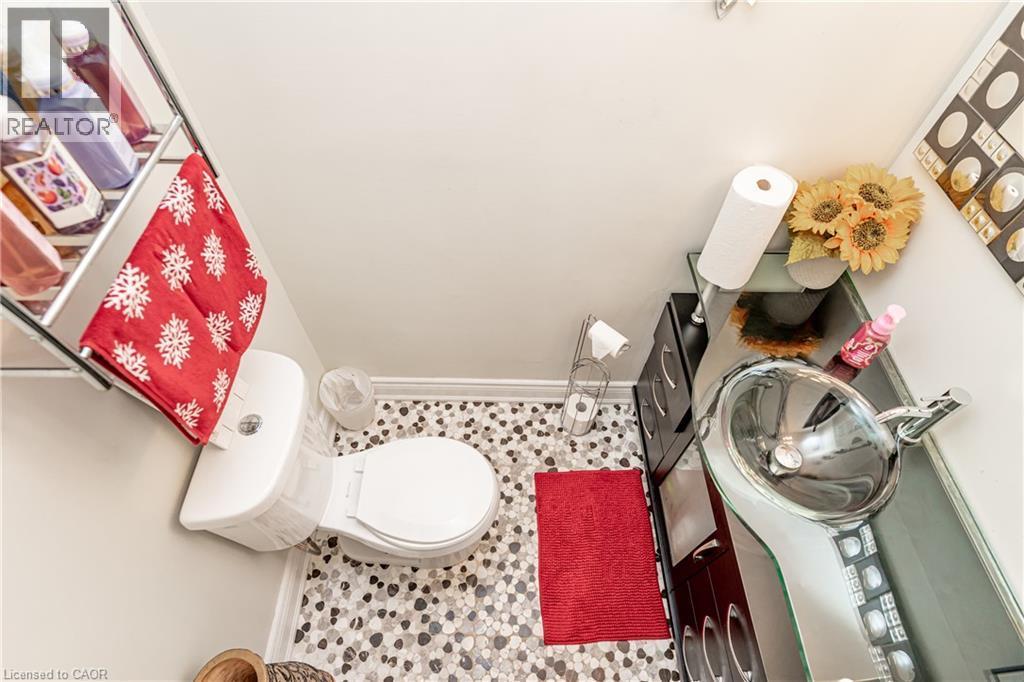 White toilet with a dual-flush mechanism - 52 Charters Road, Brampton, ON