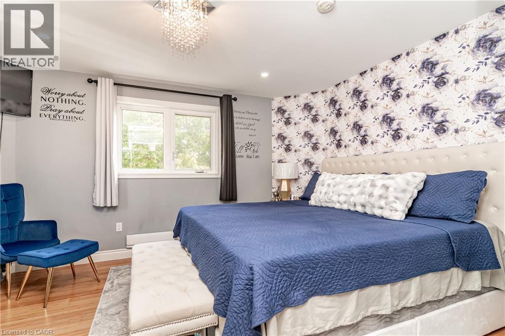 Recessed lighting, wood-finish flooring, and a decorative accent wall - 52 Charters Road, Brampton, ON