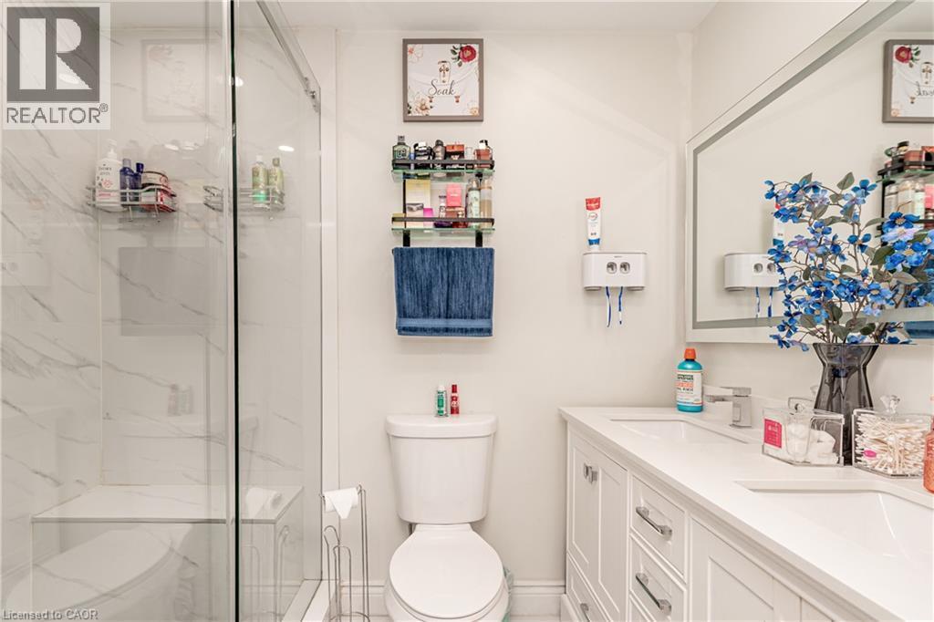 White shaker-style vanity with chrome hardware, a single rectangular sink, and a framed mirror - 52 Charters Road, Brampton, ON