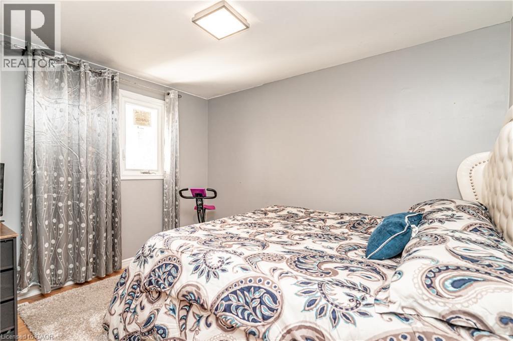 Neutral wall paint, square flush mount ceiling light, and wood-finish flooring - 52 Charters Road, Brampton, ON