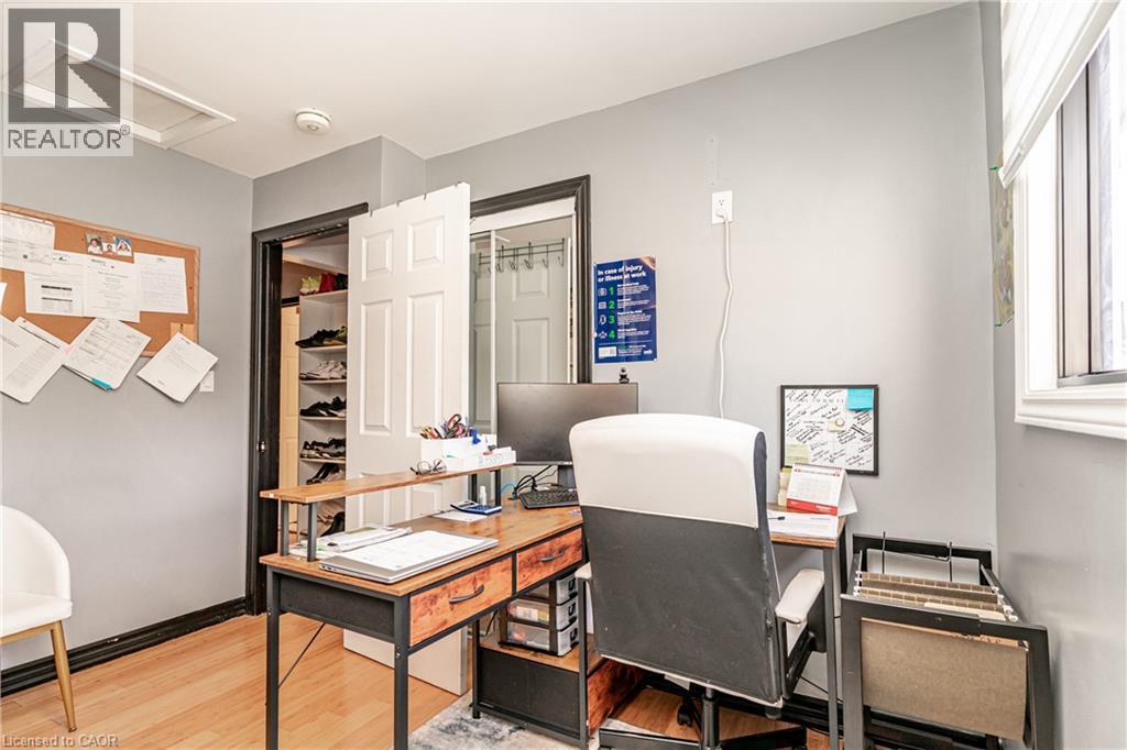 Recessed attic access hatch, light wood-finish flooring, white window blinds, white paneled door, built-in closet shelving - 52 Charters Road, Brampton, ON