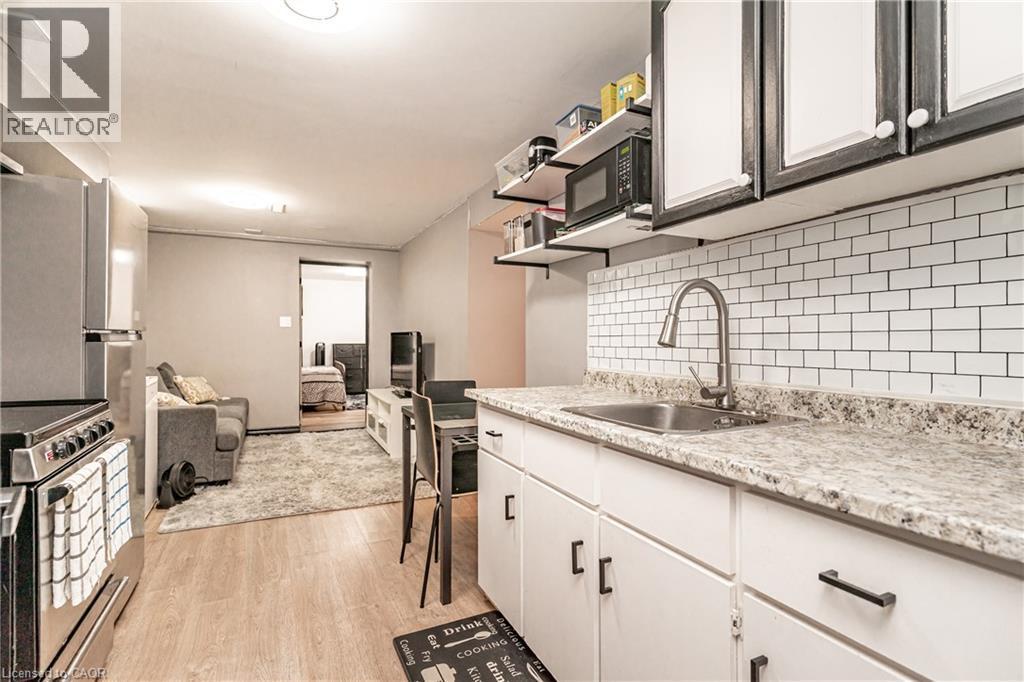 White subway tile backsplash with light-toned countertops - 52 Charters Road, Brampton, ON