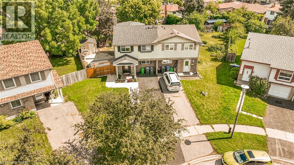 Attached two-story residence featuring a front porch and a paved driveway - 52 Charters Road, Brampton, ON