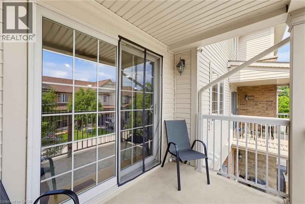 Balcony with a concrete floor, white siding, and a white railing - 541 Winston Road Unit# 50, Grimsby, ON