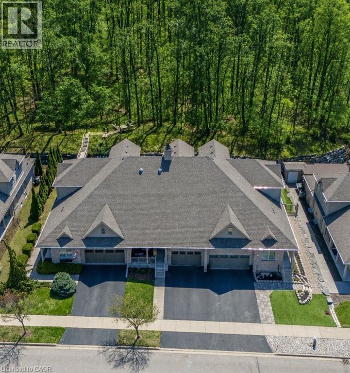 Stone facade exterior with integrated garages, asphalt driveways, and a shingled roof - 227 Chestnut Hill Crescent, Kitchener, ON
