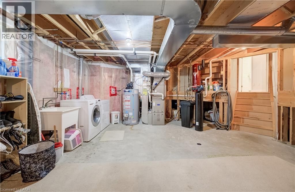 Unfinished basement with exposed ceiling joists and concrete flooring - 245 Fern Crescent, Waterloo, ON