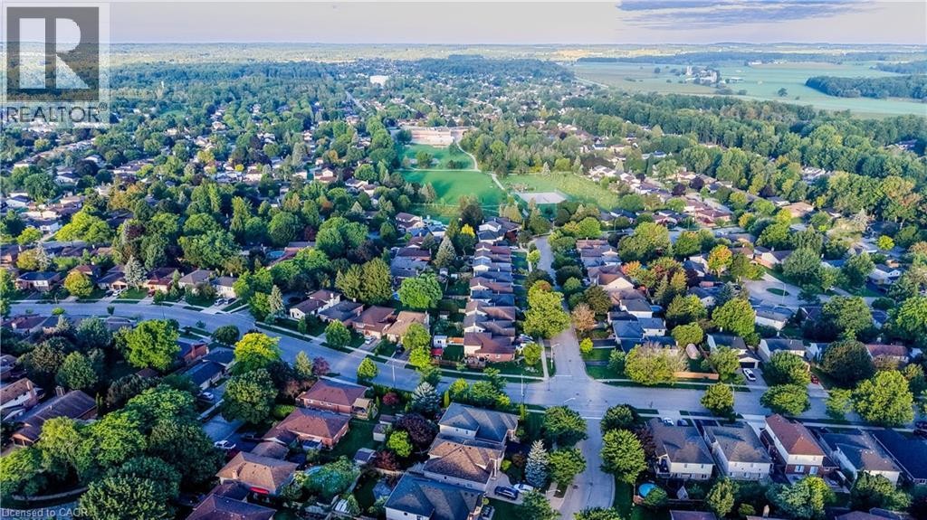 Expansive residential area featuring numerous single-family homes, mature tree coverage, and paved roads - 245 Fern Crescent, Waterloo, ON