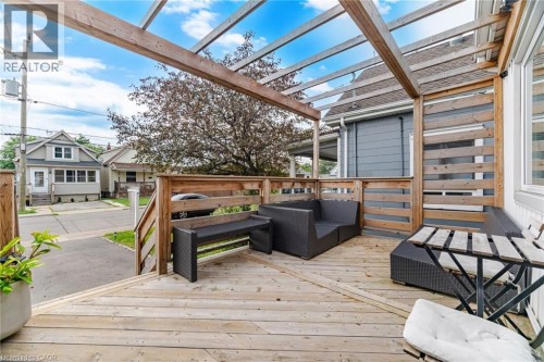 Expansive wood deck with a slatted wood pergola, wood privacy screening, and wood railing - 146 Campbell Avenue, Hamilton, ON 