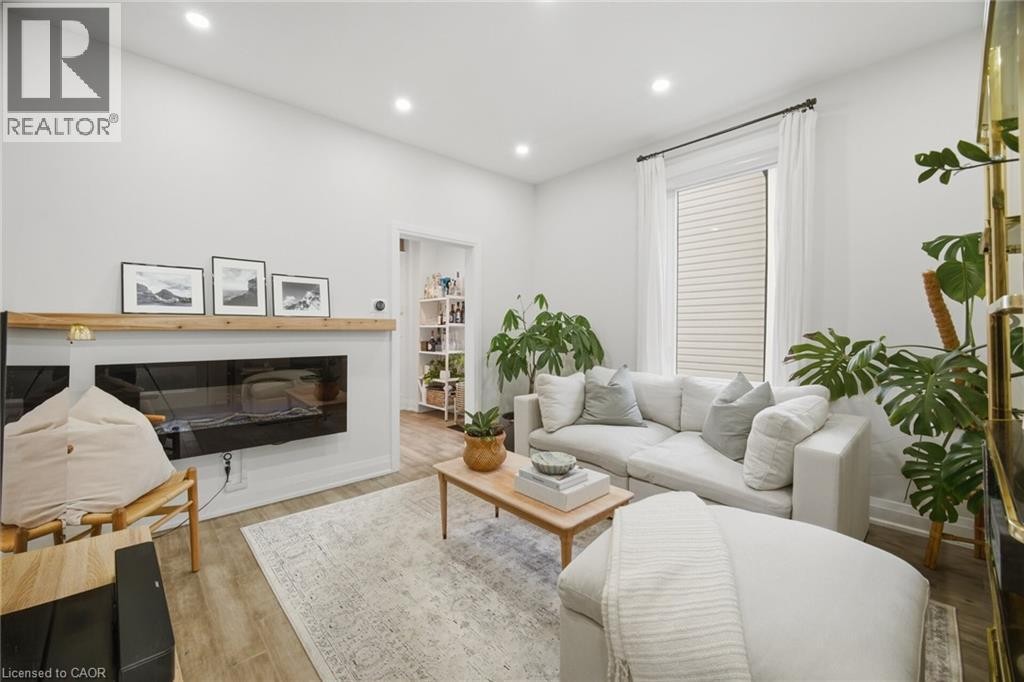 Recessed lighting, wood-finish flooring, a built-in fireplace, and a window with blinds - 146 Campbell Avenue, Hamilton, ON