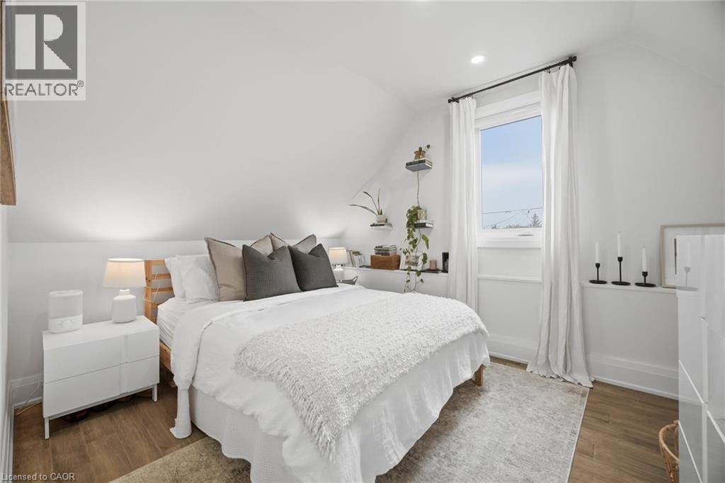 Wood-finish flooring, recessed lighting, and a white window with white drapes - 146 Campbell Avenue, Hamilton, ON