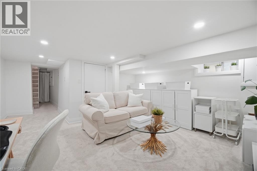 Recessed lighting, light-toned carpeting, white walls, and a white door with black hardware - 146 Campbell Avenue, Hamilton, ON