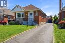 Brick exterior with a peaked roofline and front bay window - 127 Taylor Avenue, Hamilton, ON 