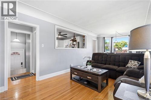 Living area featuring wood-finish flooring, light gray wall paint, and white trim - 127 Taylor Avenue, Hamilton, ON 