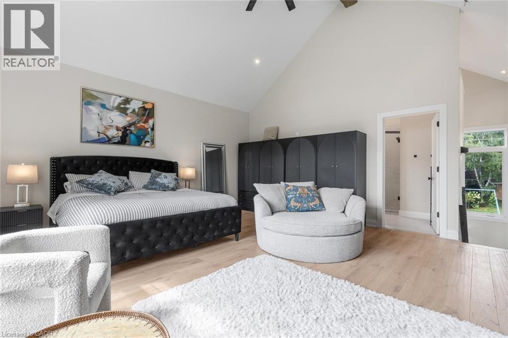 Vaulted ceiling, light wood-finish flooring, built-in storage cabinetry, recessed lighting, and a window with exterior views - 293 North Shore Boulevard E, Burlington, ON