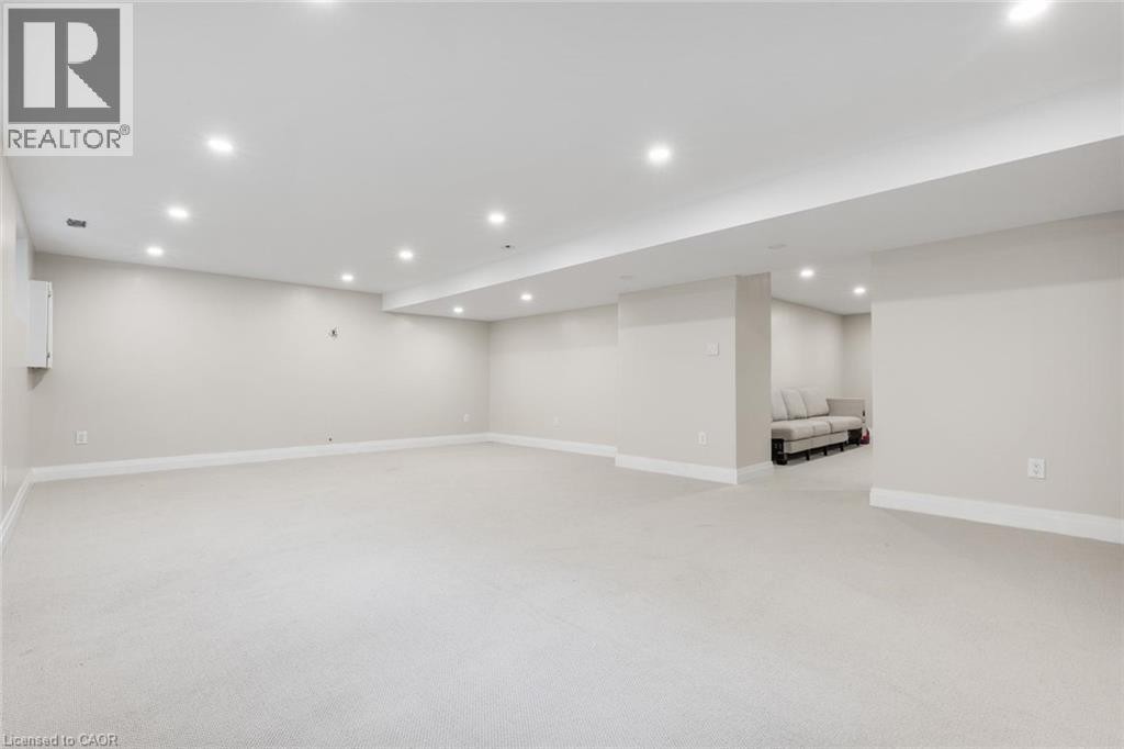 Expansive room with neutral carpeting, recessed lighting, and light-toned wall finishes - 293 North Shore Boulevard E, Burlington, ON
