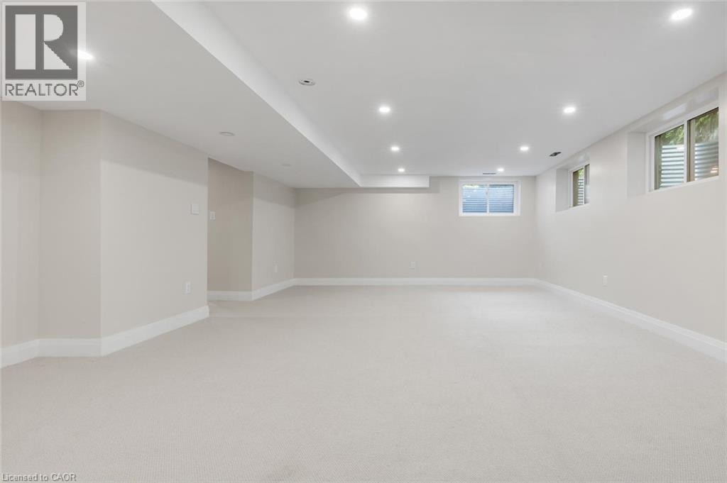 Recessed lighting, light-toned carpeting, multiple windows, and white trim accents - 293 North Shore Boulevard E, Burlington, ON