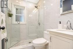 Glass Shower with Custom Marble Herringbone Floor - 