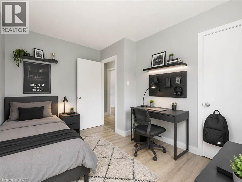 Light wood-finish flooring, light gray wall paint, and white trim - 220 Cairn Street, London, ON
