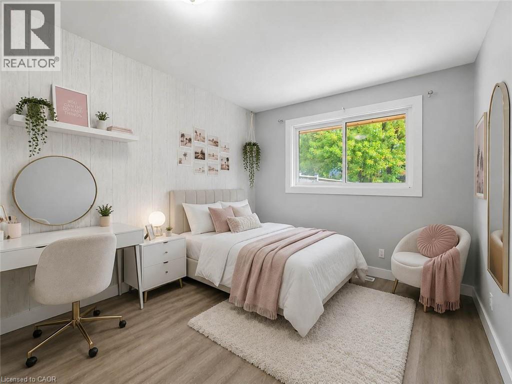 Recessed lighting, wood-finish flooring, and a window with white trim - 220 Cairn Street, London, ON