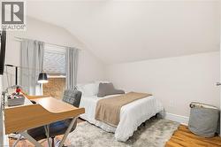 Angled ceiling with a window and wood-finish flooring - 