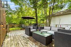 Wood-plank outdoor deck with string lighting and a surrounding wooden fence - 