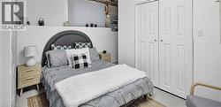 Bedroom featuring white walls and a good sized closet - 