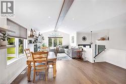 Spacious interior featuring wood flooring and a prominent exposed ceiling beam - 