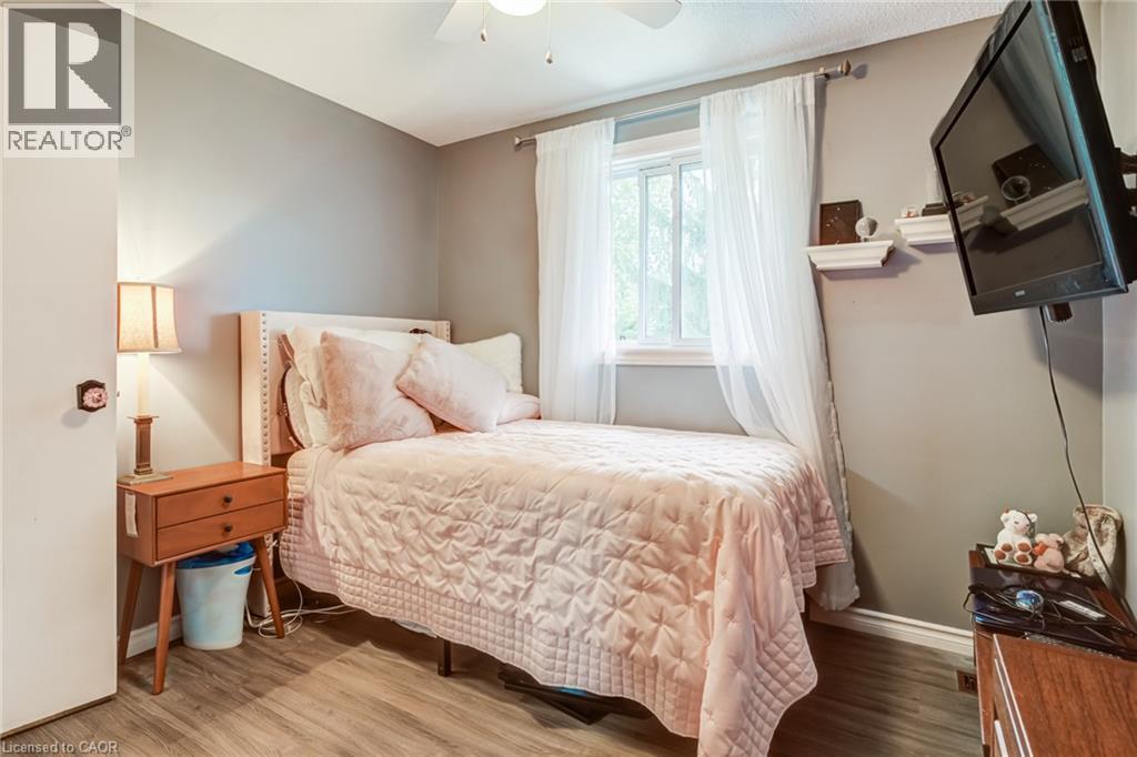 Wood-finish flooring, single window, and a ceiling fan - 106 Appleford Road, Hamilton, ON