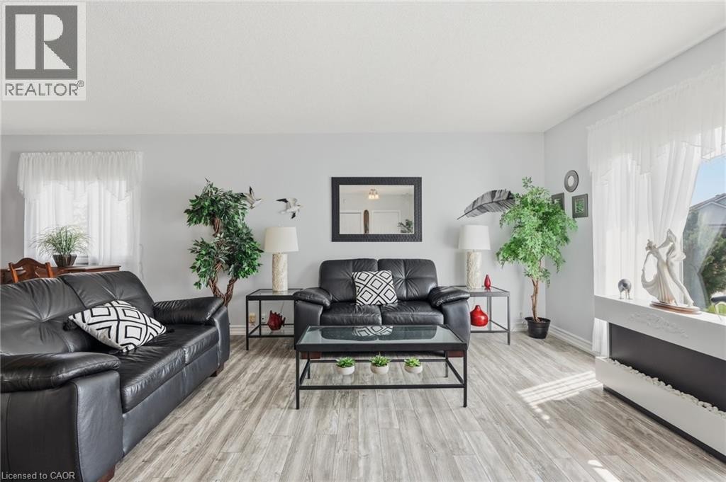 Light-toned wood-finish flooring complements light wall finishes - 9 Country Club Road, Cayuga, ON
