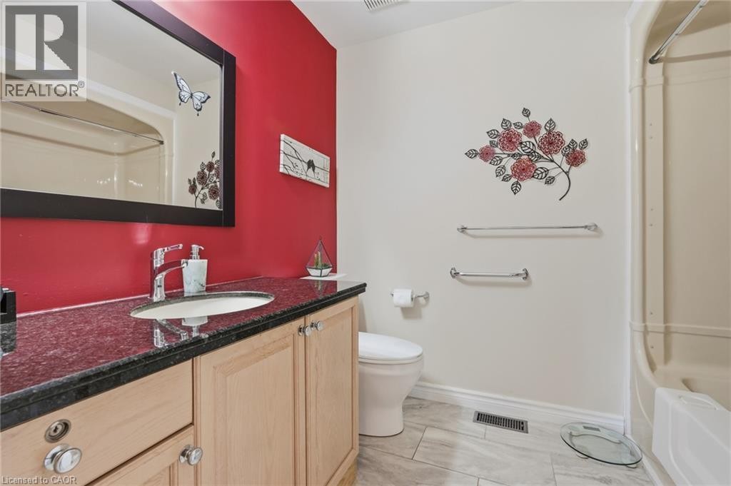 Vanity with a polished countertop and an undermount sink - 9 Country Club Road, Cayuga, ON