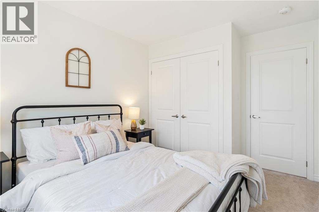 Neutral wall color, carpet flooring, paneled doors, and ceiling-mounted smoke detector - 68 Barkerville Drive, Whitby, ON