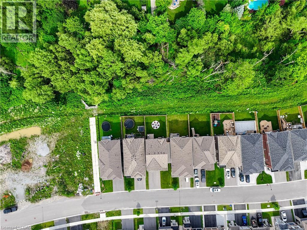 Residential properties featuring pitched roofs and paved driveways - 68 Barkerville Drive, Whitby, ON