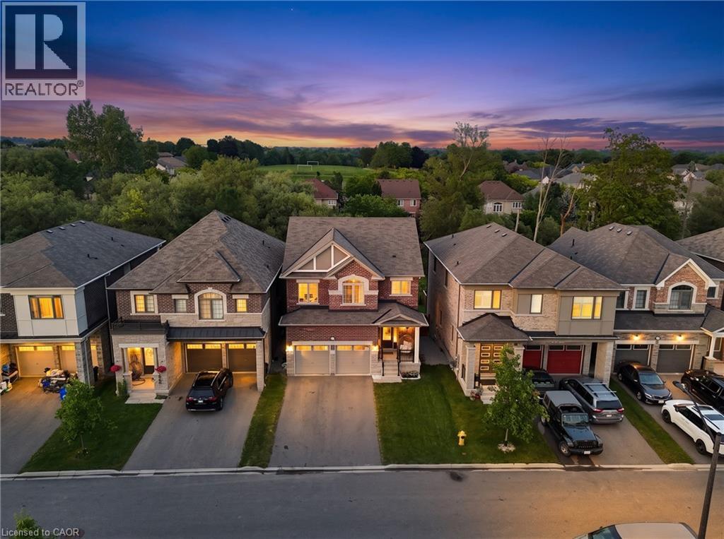Brick and stone facade, double garage, two-story design, front landscaping, and a paved driveway - 68 Barkerville Drive, Whitby, ON