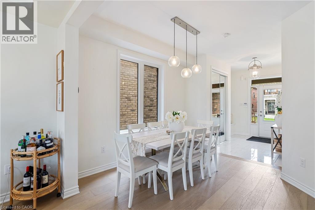 Recessed lighting, wood-finish flooring, white trim, and a three-light linear pendant fixture - 68 Barkerville Drive, Whitby, ON