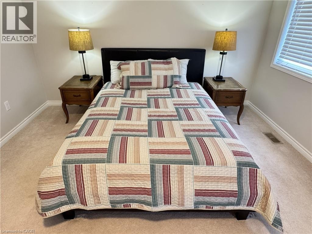 Carpeted flooring with baseboards and a window with blinds - 67 Pointer Street, Cambridge, ON