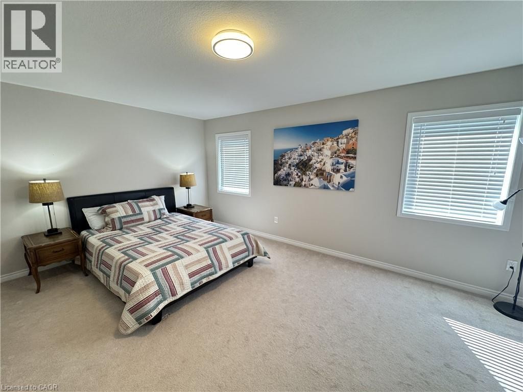 Recessed lighting fixture, light neutral wall color, two windows with blinds, and light-colored carpeting - 67 Pointer Street, Cambridge, ON