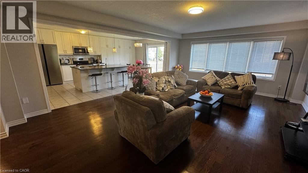 Hardwood flooring throughout, recessed lighting, and large windows with blinds - 67 Pointer Street, Cambridge, ON