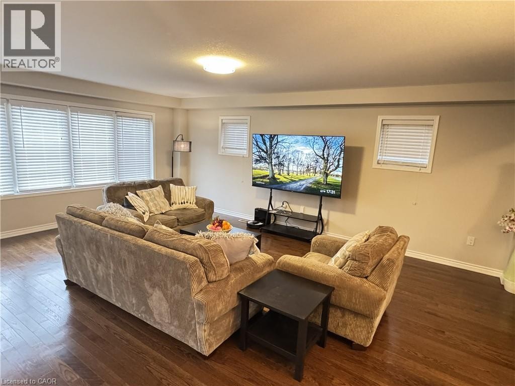 Hardwood-finish flooring, recessed ceiling lighting, multiple windows with blinds, neutral wall tones, and crown molding - 67 Pointer Street, Cambridge, ON