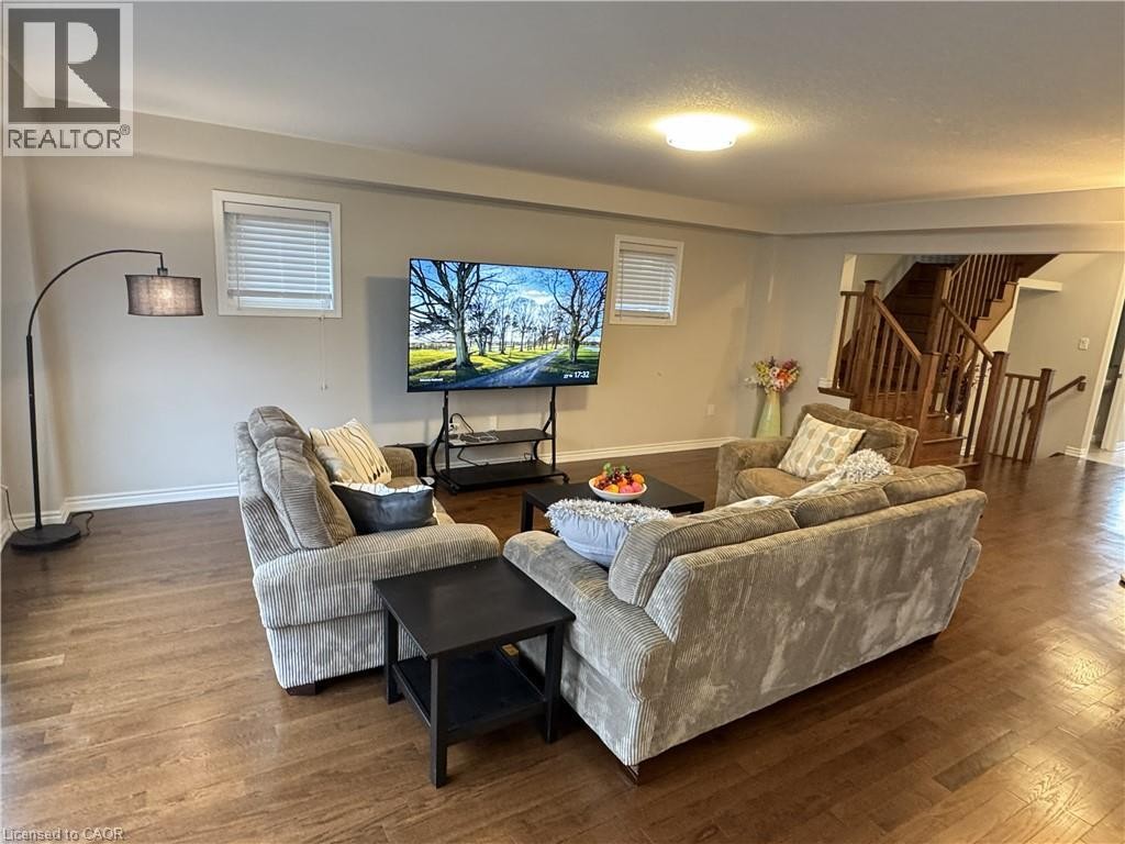 Wood-finish flooring throughout, light neutral wall tones, and recessed lighting - 67 Pointer Street, Cambridge, ON