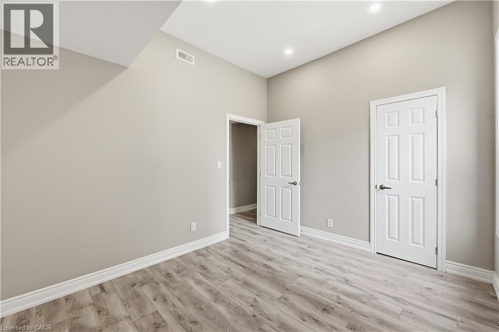Vaulted ceiling, wood-finish flooring, recessed lighting, neutral wall palette, white trim - 98 Duke Street Unit# 2Nd, Hamilton, ON