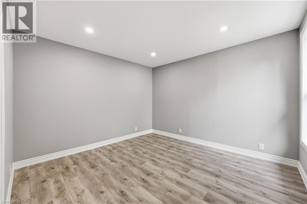 Recessed lighting, wood-finish flooring, white trim, and light gray wall finishes - 98 Duke Street Unit# 2Nd, Hamilton, ON