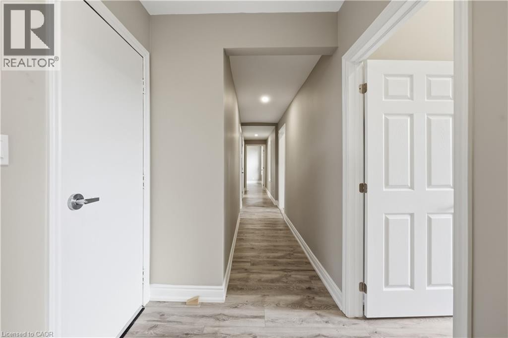 Hallway featuring wood-finish flooring, recessed lighting, and neutral wall tones - 98 Duke Street Unit# 2Nd, Hamilton, ON