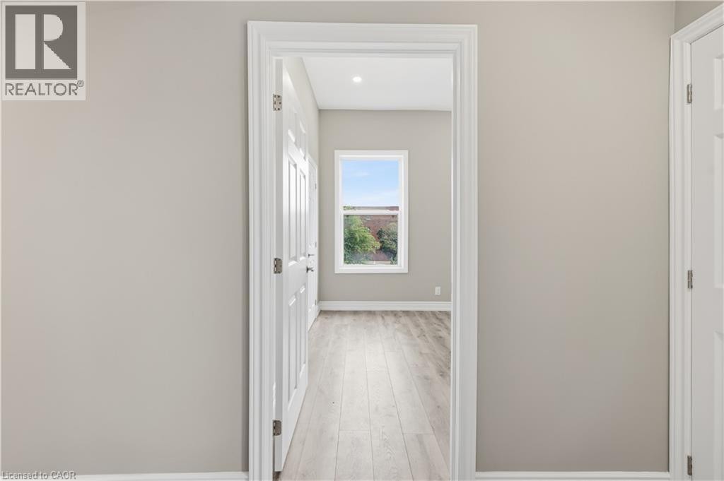 Light wood-finish flooring, white trim, recessed lighting, white window frame - 98 Duke Street Unit# 2Nd, Hamilton, ON