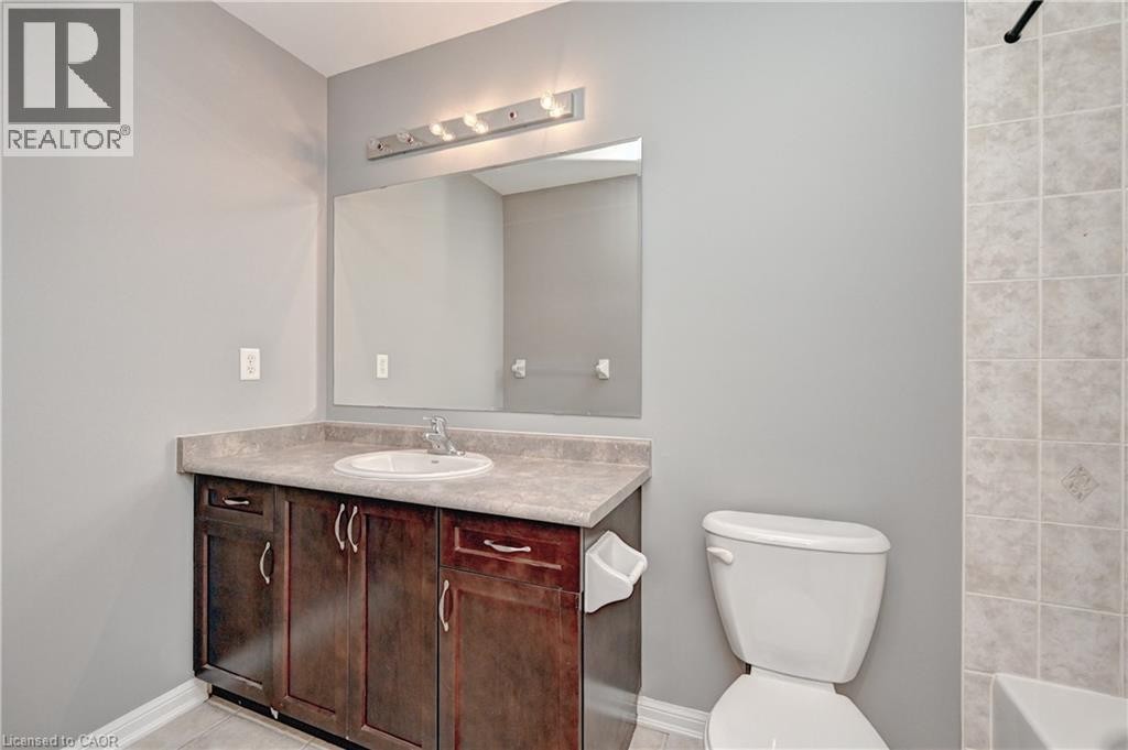 Dark wood-finish vanity with a built-in sink and countertop - 103 Blackbird Circle, Cambridge, ON