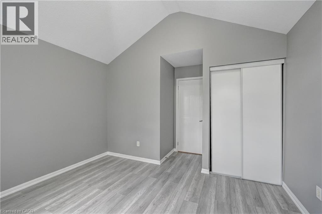 Vaulted ceiling accentuates this space featuring wood-finish flooring - 103 Blackbird Circle, Cambridge, ON