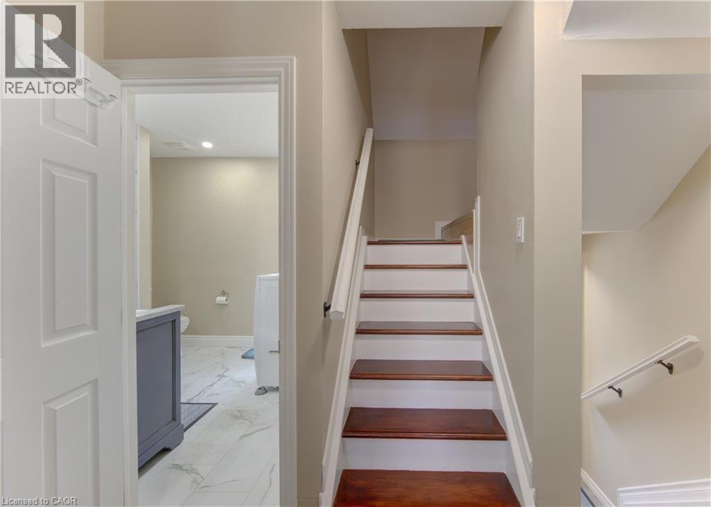Wood-finish stair treads with white risers and handrails - 104 Mausser Avenue, Kitchener, ON