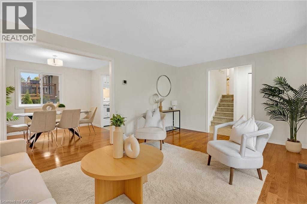 Hardwood flooring extending throughout, spacious entryway, staircase with carpeted treads, and recessed lighting - 7 Underhill Crescent, Kitchener, ON