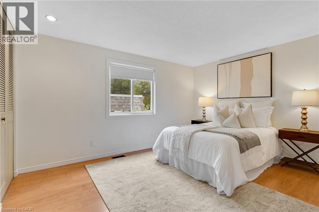 Recessed ceiling lighting, wood-finish flooring, white walls, and a window with roller shade - 7 Underhill Crescent, Kitchener, ON