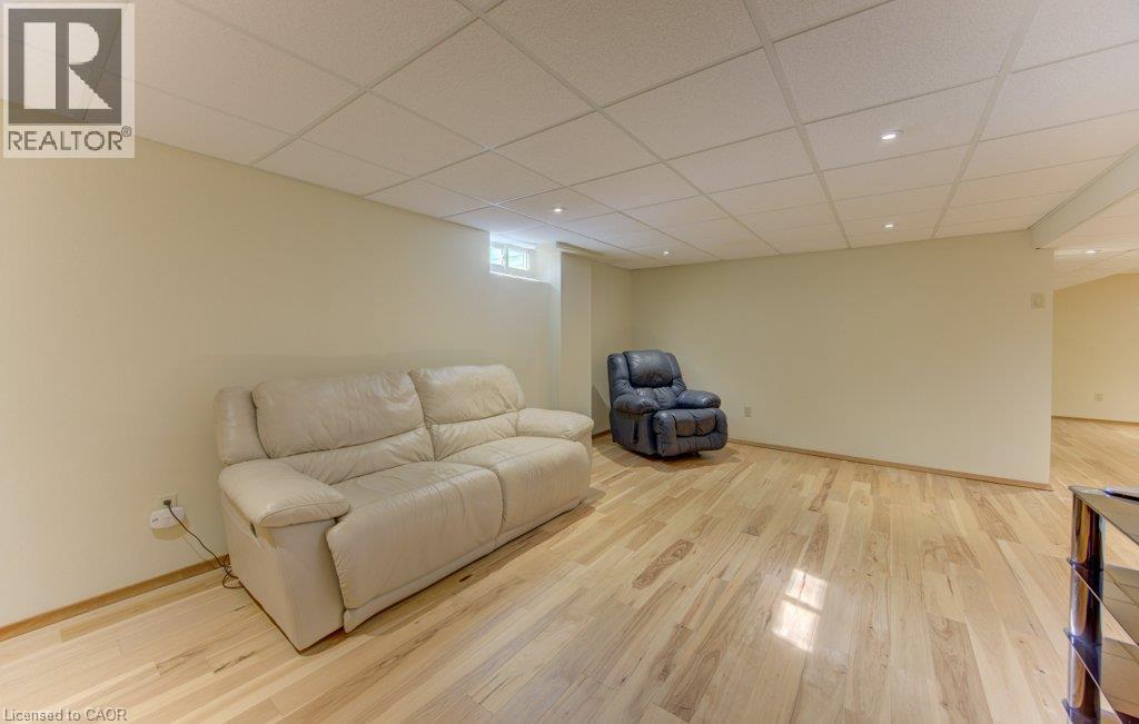 Spacious room featuring light wood-finish flooring, recessed lighting, and a drop ceiling - 238 Mcgarry Drive, Kitchener, ON