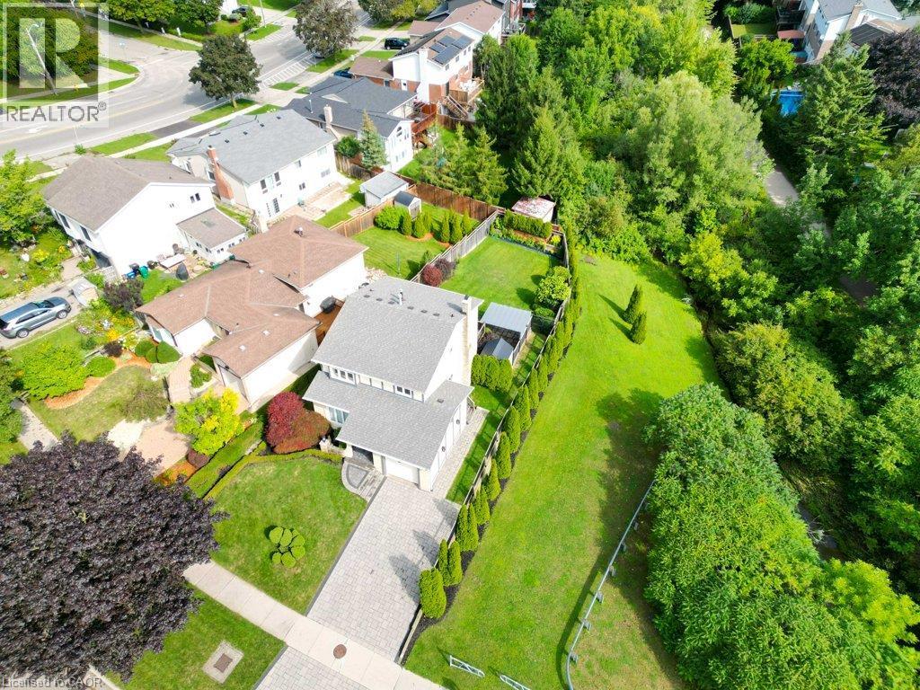 Two-story residence with a light gray facade, attached garage, and a paver driveway - 238 Mcgarry Drive, Kitchener, ON